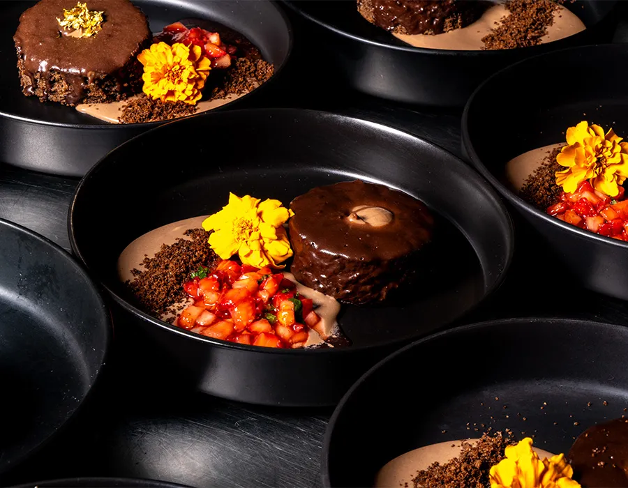 Chocolate dessert with fresh strawberries and marigold flowers