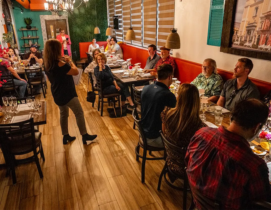 Guests seated at long tables in the Rumbo 52 dining room during a dinner event